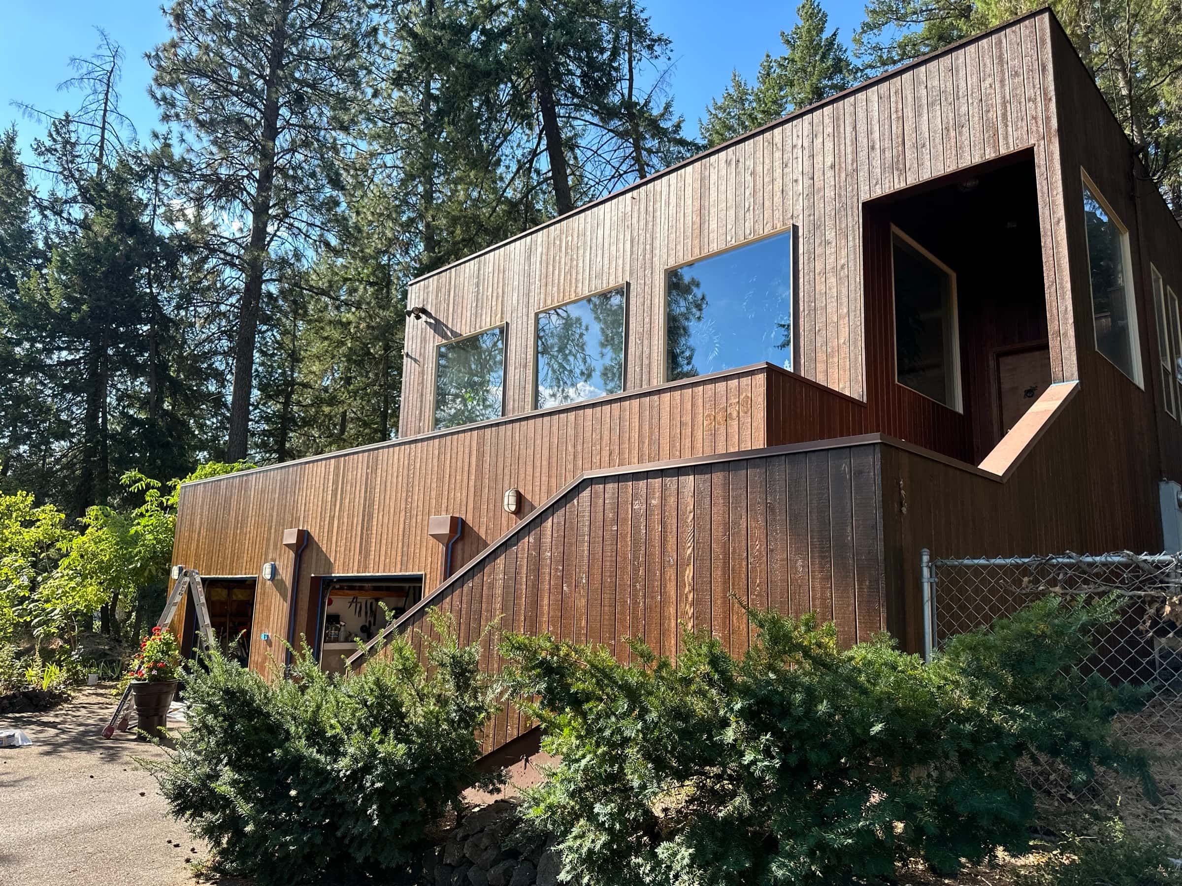 Modern wood siding staining on a Spokane, WA forest home with stepped facade