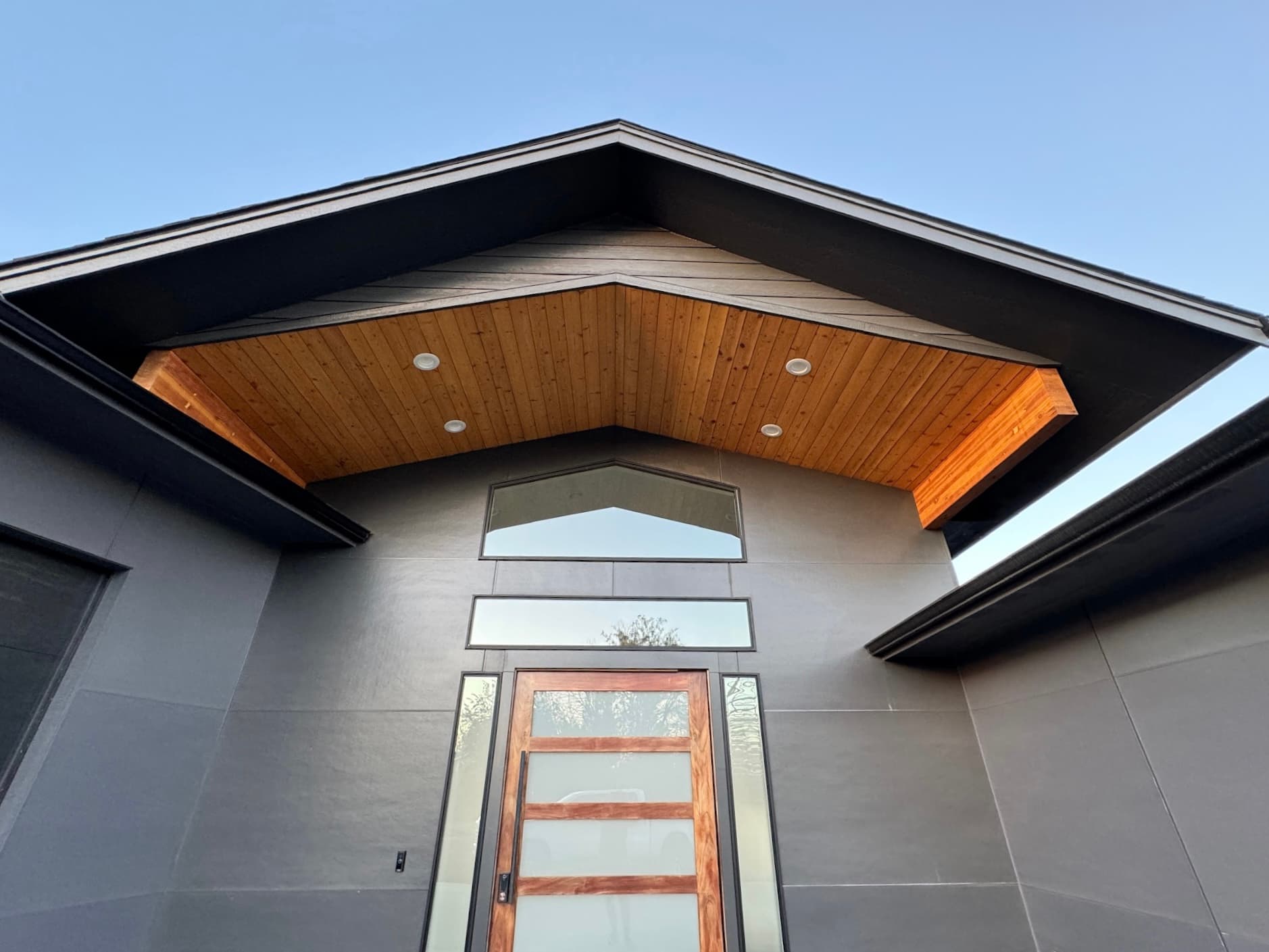 Modern home entrance with wood gable detail finished by Pro Arkh