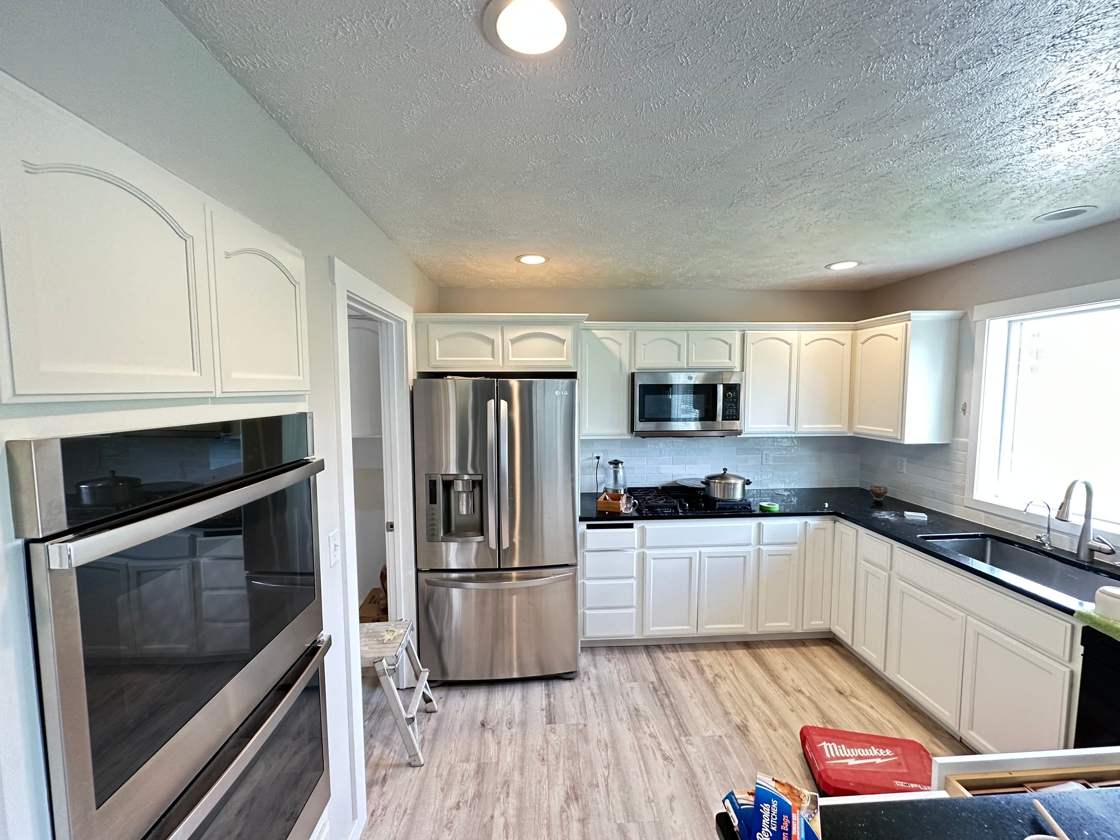 White kitchen cabinet refinishing in a bright Spokane, WA interior