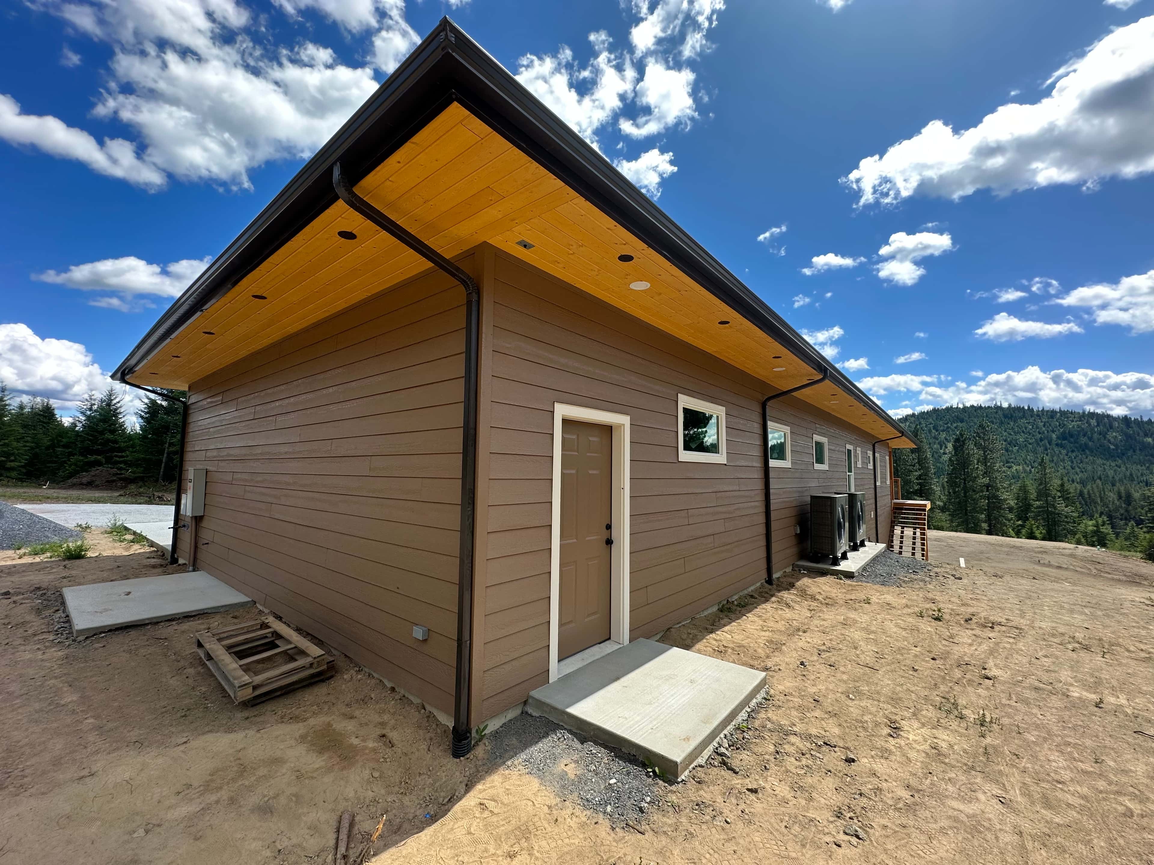 Tan horizontal siding and exposed wood on a Spokane home